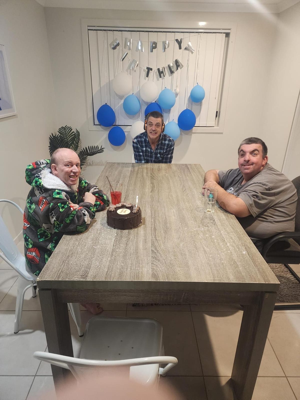 A birthday celebrated around the dining table in one of the homes.
