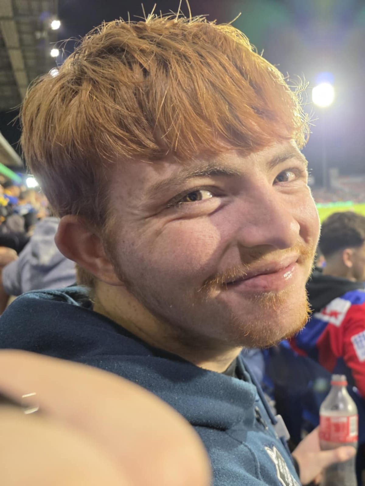 A participant enjoying a night out at the football, supported by the Sanctuary team.